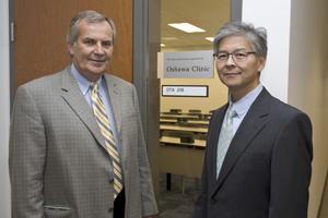 Harry Horricks, CEO, Oshawa Clinic and Dr. Peter Lai Fatt, medical director, Oshawa Clinic, unveil donation recognition plaque at 61 Charles Street.