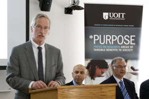 From left: Dr. Michael Owen, associate vice-president, Research, UOIT; Atul Mahajan, president and CEO, Oshawa PUC Networks (seated); and Dr. Vijay Sood, associate professor, Faculty of Engineering and Applied Science, UOIT (seated).