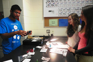 CERL's Diego de Andrade (Science Without Borders exchange student from Brazil) explains sustainable energy research at UOIT to Grade 10 science students at Oshawa's Maxwell Heights Secondary School. Below right: Andrea Miller (left), Grade 10 science teacher at Maxwell Heights receives renewable energy kits from Ed Secnik, Research Laboratory Manager, CERL, UOIT.  Top banner image: Maxwell Heights Grade 10 academic science class.