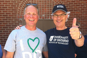 From left: President Don Lovisa, Durham College; and President Tim McTiernan, UOIT. Right: Team UOIT wheels along King Street in downtown Oshawa in front of the Regent Theatre.