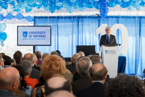 President Tim McTiernan addresses the large crowd at UOIT's 10th anniversary celebration on September 4, 2013. Top image: Cutting the 10th anniversary cake: UOIT President Tim McTiernan (right) and UOIT President Emeritus Gary Polonksy (left) are surrounded by elected representatives and other dignitaries.