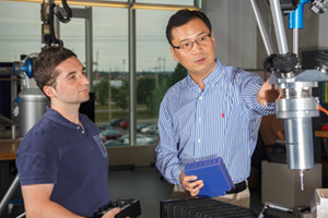 Dr. Dan Zhang consulting with research colleague in UOIT's Advanced Robotics and Automation Lab