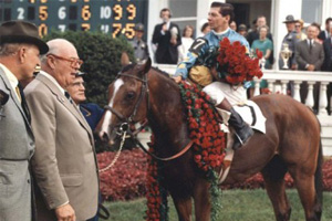 Northern Dancer in the winner's circle at the 1964 Kentucky Derby in Louisville, Kentucky (standing, left: Northern Dancer's owner E.P. Taylor).