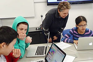 Dr. Suzanne de Castell, Dean, FEd, teaching coding to students.