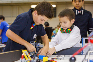 Hectic action at the FIRST LEGO League Ontario East Championships, as students sporting LEGO bow ties tend to their robot during competition, January 17, 2015.