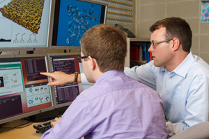 Master of Science in Materials Science student Graham Clendenning (left) and Dr. Isaac Tamblyn, Assistant Professor, Faculty of Science, review simulation results from Clendenning's research on artificial photosynthesis.