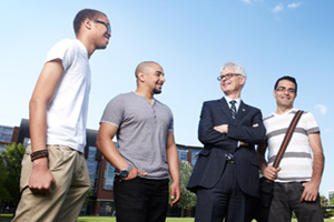 UOIT President Tim McTiernan (second from right) chats with students at Polonsky Commons.
