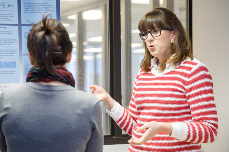 Master of Arts in Education student Jessica Clarkson explains her research at the symposium.
