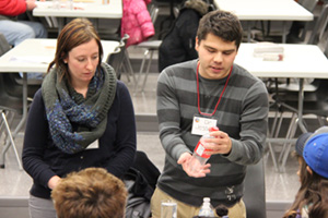 UOIT PhD candidate Jesse Allan (right) demonstrates science experiment at Durham District School Board's Aboriginal Family Network Night at Oshawa's G.L. Roberts Collegiate and Vocational School.