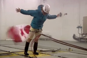 Leanna McLean of The Weather Network enduring 90 km/h wind and driving rain in front of the nozzle of the ACE climatic wind tunnel.