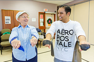 Kinesiology student David Jagroop (right), helps a fitness program participant with resistance-training exercises.