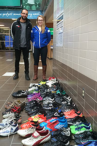 Victor Sateri and Jessica Mithrush collect soccer cleats for Uganda