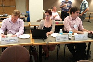 From left: Nicholas Chornoboy, Master of Applied Science, Nuclear Engineering; Margarita, Tzivaki, PhD, Nuclear Engineering; and Martin Magill, Master of Science, Modelling and Computational Science work on nuclear security case studies during a workshop held at the MIT Nuclear and Plasma Sciences Building. 