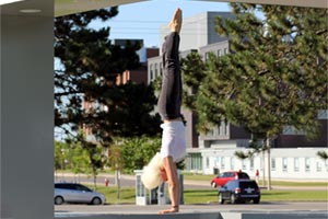 Partial image of Category A winning entry (Physical Fitness @ UOIT), taken by Lydia Stewart-Goodison. Image shows Svetlana Novak, Graduate Professional Development Co-ordinator, Office of Graduate Studies doing a handstand inside The Cube (Conlin Road and Simcoe Street). See story link for full image.  