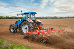 tractor on farm loosening soil