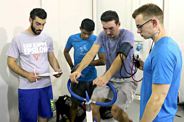 Kinesiology students set up stationary bikes in one of the ACE climate chambers, with the temperature cranked up to 35 degrees Celsius and the humidity dialed up to 60 per cent.