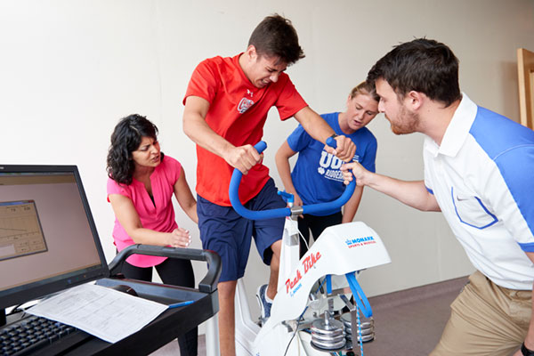 From left: Dr. Shilpa Dogra, Assistant Professor, FHS with Oshawa Generals candidate Domenic Commisso, Kinesiology student Deanna Nickle and Ryan Foley, Kinesiology Lab Technician, UOIT. Commisso was performing the Wingate Anaerobic Test, which is used to measure peak anaerobic power, as well as anaerobic capacity.