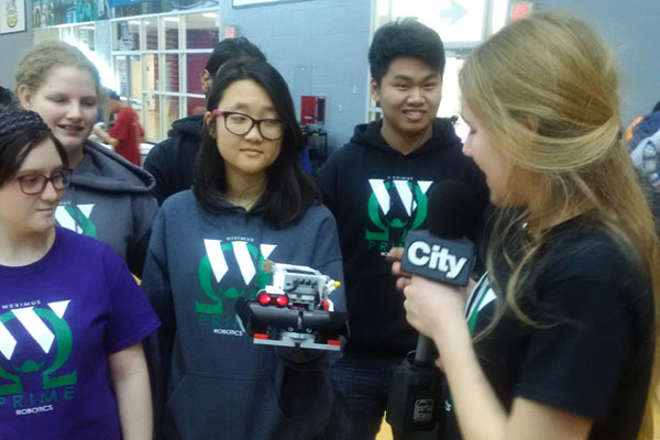 Students from Scarborough's Wexford Collegiate School for the Arts explain their robot creation during an interview with videographer from Toronto's CityNews.