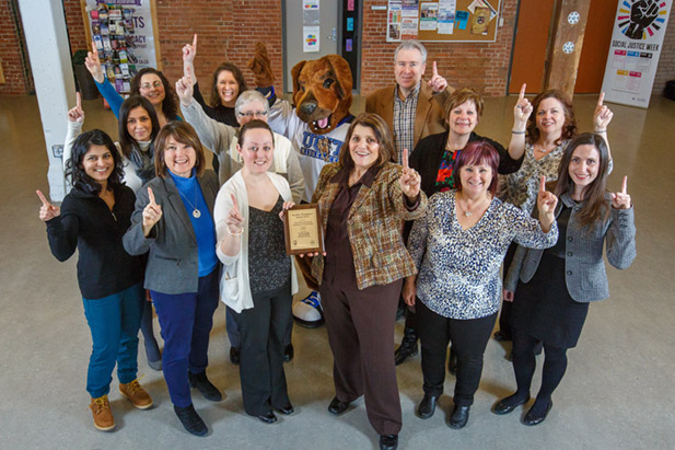 Hunter the Ridgeback helps the Healthy Workplace Committee celebrate the university's second-consecutive Healthy Workplace Award from the Regional Municipality of Durham.