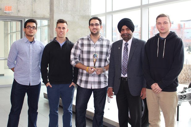 UOIT's Ontario Engineering Competition Senior Design Team. From left: Shivang Rai; Madison Bratina; Jean-Paul Basacchi; Dr. Tarlochan Sidhu, Dean, Faculty of Engineering and Applied Science; Jonathon Buisman. (below right: OEC trophy)