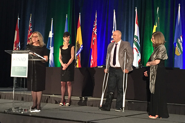 Arlene de la Rocha (at podium) receives HUB Fellowship from the Registered Nurses' Association of Ontario's annual general meeting in Toronto, Ontario.