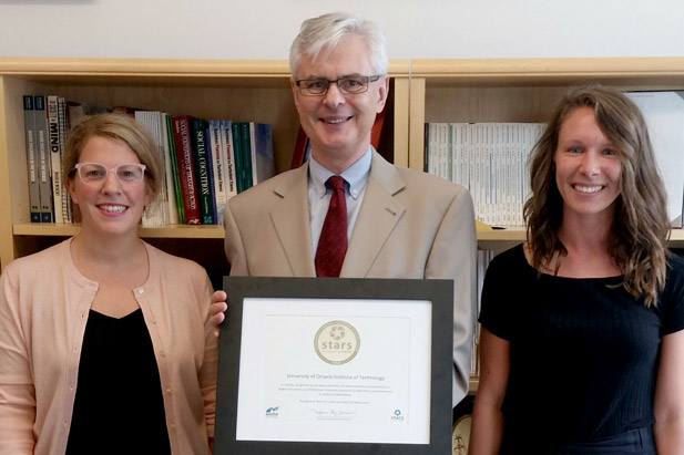 UOIT President Tim McTiernan, PhD (centre) with Melissa Mirowski, Asset and Sustainability Planner, and Shannon Oletic, Project Planning Officer, OCIS.