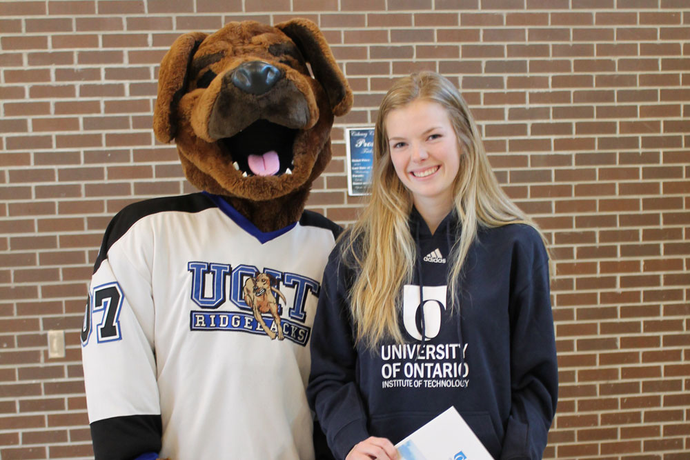 2016-2017 Founder’s Scholarship recipient Ainsley Leguard (right) with UOIT mascot Hunter the Ridgeback.