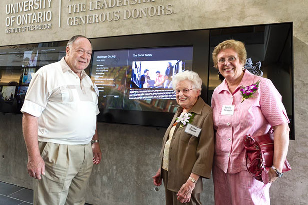 Anne Sabat (centre), with niece Sylvia Boissoin (right) and her husband Ron, in 2012 at the university’s donor wall unveiling in the Energy Systems and Nuclear Science Research  Centre.