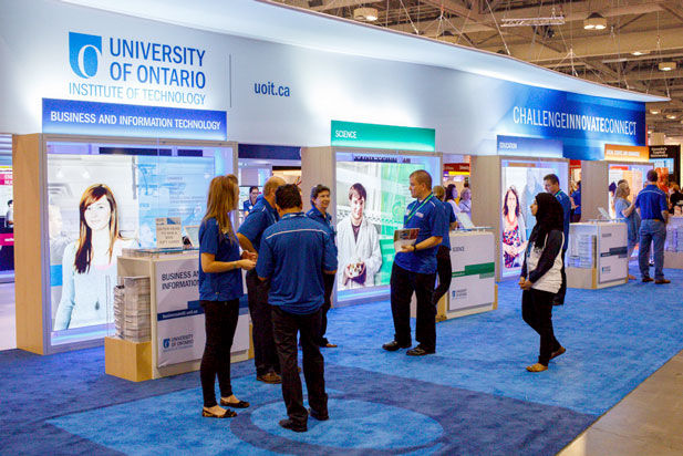 Visitors explore UOIT's booth at the Ontario Universities' Fair. 