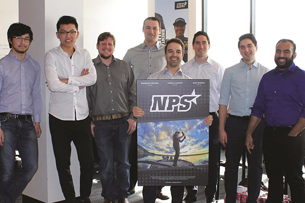 FBIT alumnus Dan Miguel (Bachelor of Commerce, 2007) holds the company sign with National ProStaff colleagues. Fellow UOIT alumnus and National ProStaff co-founder Chris Lazarte is just to the right of Dan Miguel (in the white shirt). 