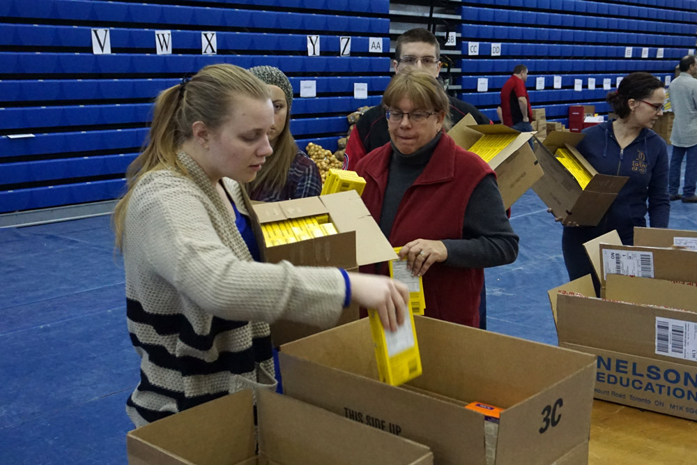 Volunteers help pack hampers for 2016 Holiday Food Drive.