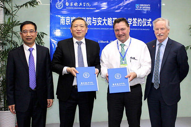 Douglas Holdway, PhD, Interim Vice-President, Research, Innovation and International (second from right) and Michael Owen, PhD, Dean, Faculty of Education (right), sign Memorandum of Understanding with officials of Nanjing Xiaozhuang University in Nanjing, China (March 15, 2017).