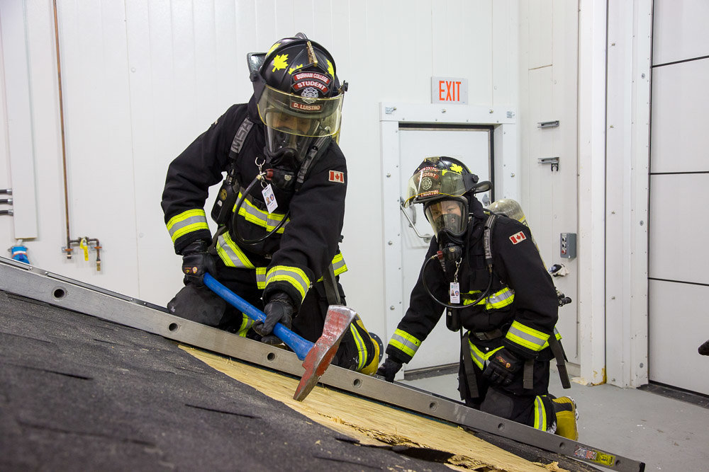 Firefighter students practice forced entry techniques.