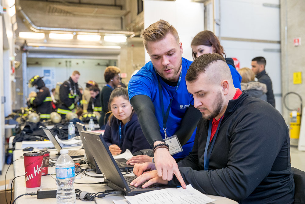 UOIT Kinesiology and DC Fitness and Health Promotion students assess physiological data collected from firefighter students during the simulations.