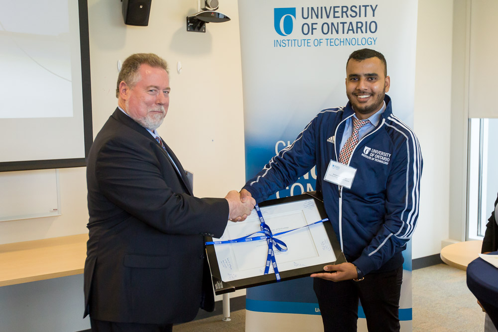Mohammed Yasin Ali, Electrical Engineering master’s degree student (FEAS), presents Mel Hyatt, President-Elect, PWU, with a certificate of appreciation signed by FEAS students. 