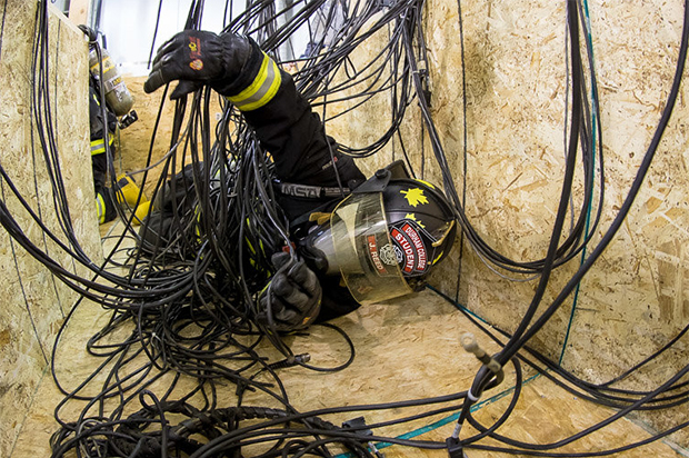 A firefighter student navigates through a heat maze during the ACE Firefighter Environmental Stress Workshop.