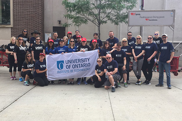 The cheering of more than 30 University of Ontario Institute of Technology staff members echoed throughout downtown Oshawa on June 21 as the group pedaled a 30-seat bike through the city’s core.