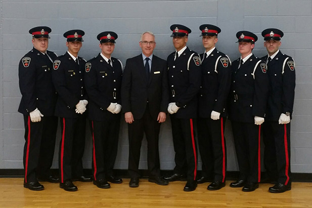 Graduates who joined the Durham Regional Police Service as constables in 2017. From left: Joe McLellan; Dan Robertson; Dylan Dever; Robert Bailey, PhD, Acting Provost and Vice-President, Academic, University of Ontario Institute of Technology; Stephen Gillings; Wallace Peddle; Melissa Berney; and Eric McKenzie.