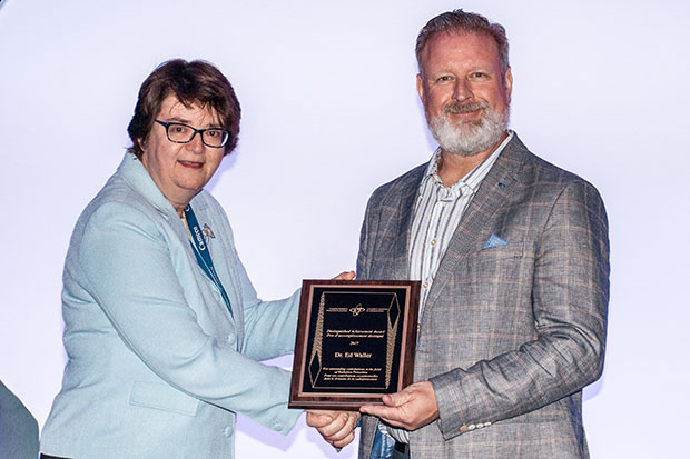 Ed Waller, PhD, Professor, Faculty of Energy Systems and Nuclear Science (right) accepts the Canadian Radiation Protection Association's 2017 Distinguished Achievement Award from Liz Krivonosov, President, Krivonosov Risk Management Consultants Inc. (in Saskatoon, Saskatchewan, June 6, 2017).