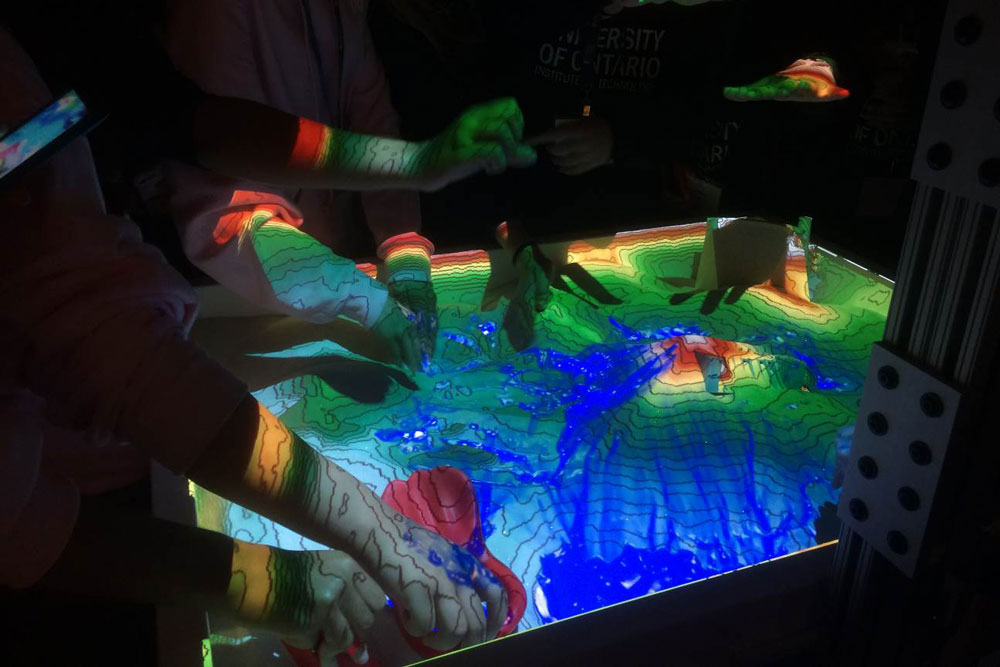 Bermuda High School students build a representation of Bermuda in the FESNS Augmented Reality Sandbox.