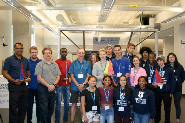 From left: Warwick Academy students and instructors pose with their sailboats alongside Sharman Perera, Senior Lecturer and Laboratory Manager, Callan Brown, Lab Specialist and master's student, and Dr. Glenn Harvel, Associate Dean.