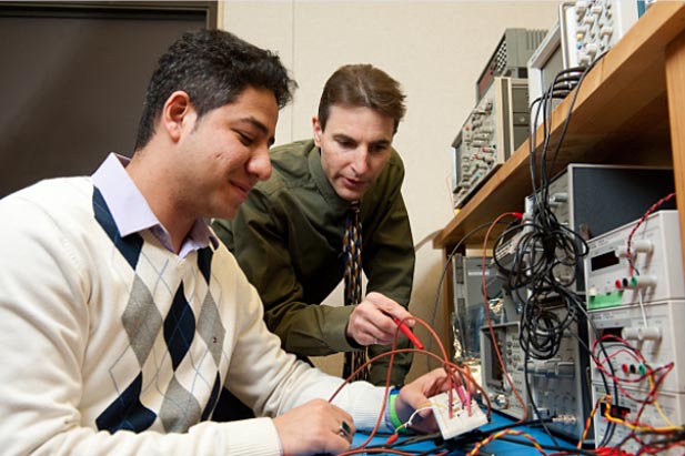 Through the NRC-IRAP program, the university will provide access to development and testing facilities for robotics and automation projects. In this photo, Langis Roy, PhD, Dean of the university's School of Graduate and Postdoctoral Studies (right) offers advice to a researcher.  