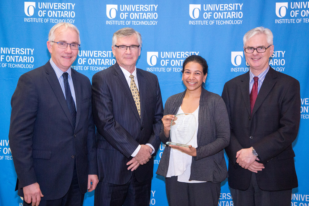 Staff Excellence Award (Professional/Managerial)*. From left: Robert Bailey (Interim Provost and VP Academic), Michael Dewson (Interim Assistant VP, HR), Monica Jain (Student Life)* and President Tim McTiernan.
