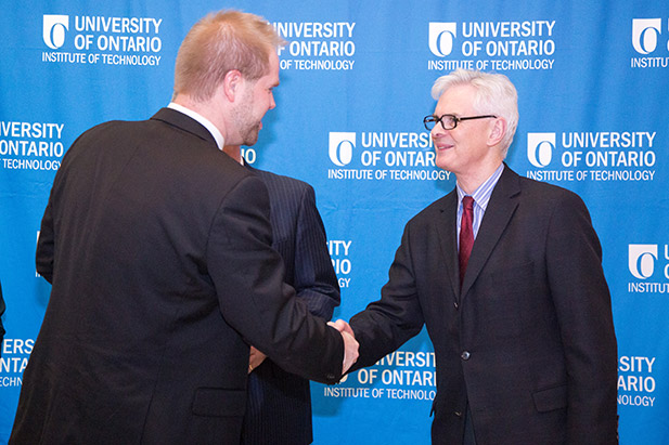 President and Vice-Chancellor Tim McTiernan, PhD (right), greets award recipients at the university's annual Awards of Excellence recognition event on December 5, 2017 (see awards gallery below for specific recipients).