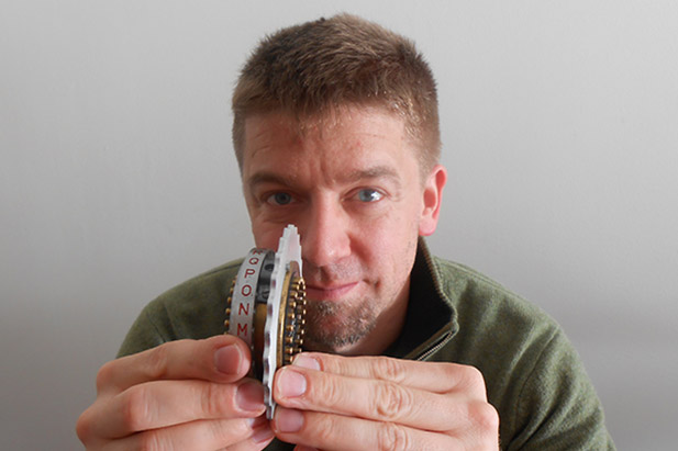 Peter Berg, PhD, former Associate Professor of Physics at the University of Ontario Institute of Technology (currently Professor of Mathematics and Physics, and Chair of the Department of Science at the University of Alberta), holds a rotor from an Enigma Cipher Machine. Dr. Berg is among the speakers at a free lecture on cryptanalysis March 2 at the university's Regent Theatre.