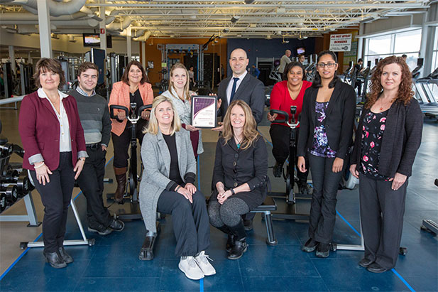 Members of the university's Healthy Workplace Committee flank Jenn Sullivan, Public Health Nurse, Durham Region Health Department (back row, centre) as she presents the Healthy Workplace Award to Jamie Bruno, Assistant Vice-President, Human Resources.