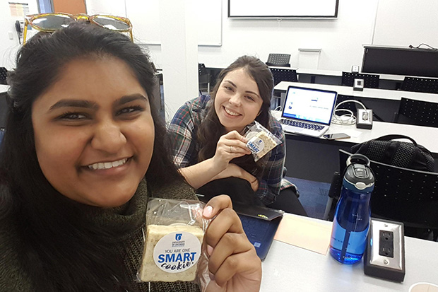 From left: Fourth-year Communication and Digital Media Studies (CDMS) students Marissa George and Hannah Scott picked up their cookies at the university's downtown Oshawa location. 