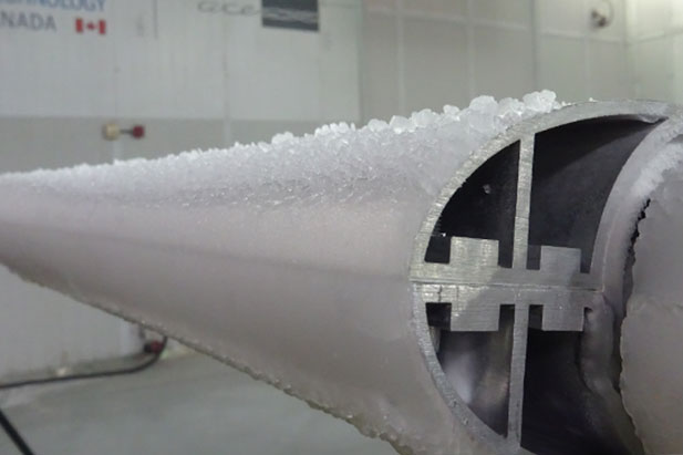 An airfoil (simulating the wing of airplane) is coated with freezing rain inside the ACE Climatic Wind Tunnel at the University of Ontario Institute of Technology.