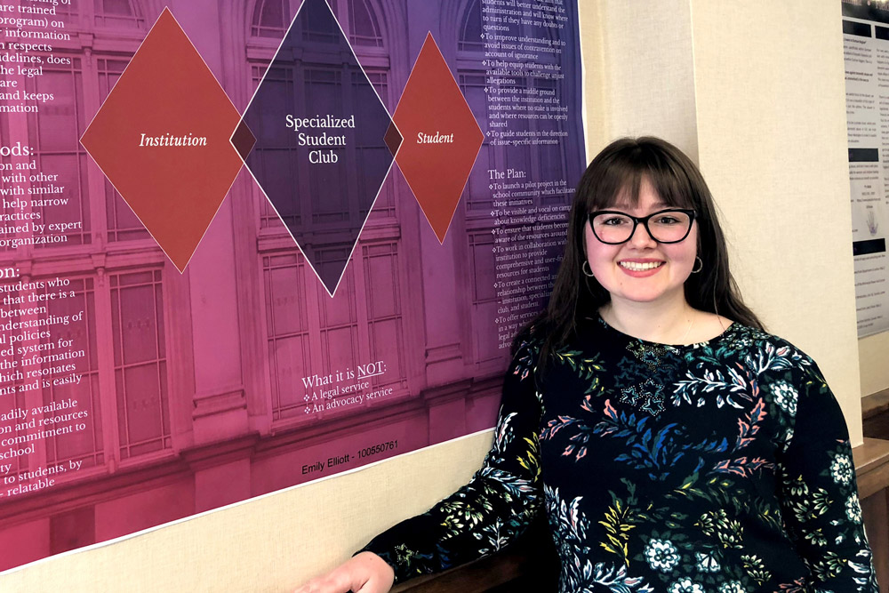 Emily Elliott with her poster showcasing her Practicum placement experience with the University of Ontario institute of Technology's Office of the University Secretary and General Counsel.