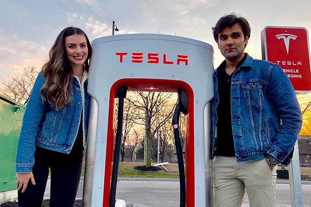 Second-year Mechatronics Engineering students Rachel Illman (left) and Hamayal Choudhry (right) check out a newly built Tesla supercharger station on Brock Road in Pickering, Ontario. Both have earned internships with Tesla Inc. in Fremont, California.